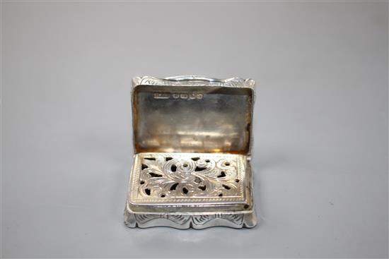 A Victorian silver shaped rectangular vinaigrette, Hilliard & Thomason, Birmingham, 1884 and one other.